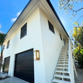 White building black garage door